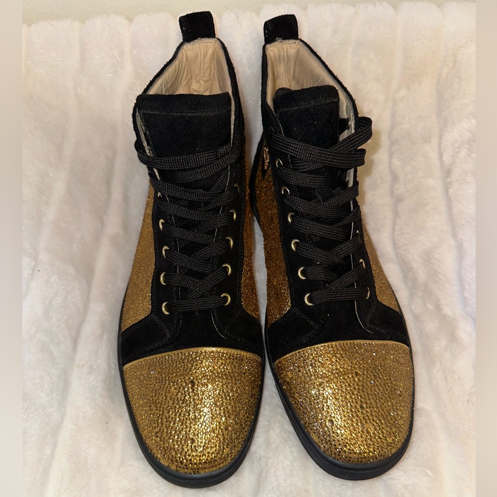 Men’s gold and black Christian Louboutin sneakers.